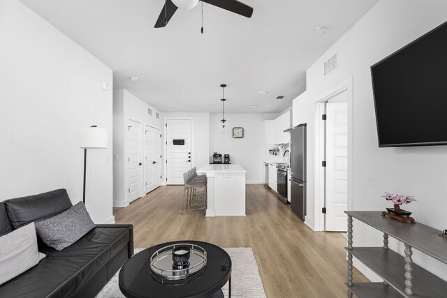 2500 Longview St Unit 418, Austin, TX 78705 - living area with ceiling fan, light wood finished floors, and baseboards