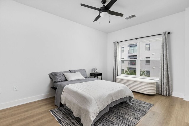 2500 Longview St Unit 418, Austin, TX 78705 - bedroom featuring light wood-type flooring, baseboards, and a ceiling fan