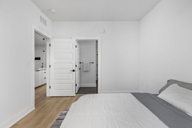 2500 Longview St Unit 418, Austin, TX 78705 - bedroom with light wood-type flooring and baseboards