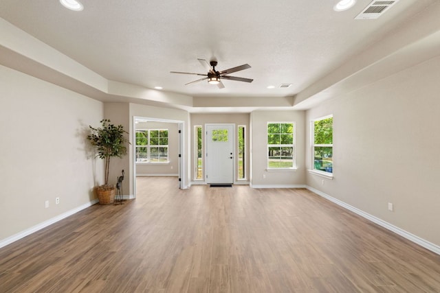 125 Channel Dr, Sunrise Beach, TX 78643 - unfurnished living room featuring a ceiling fan, visible vents, wood finished floors, and baseboards