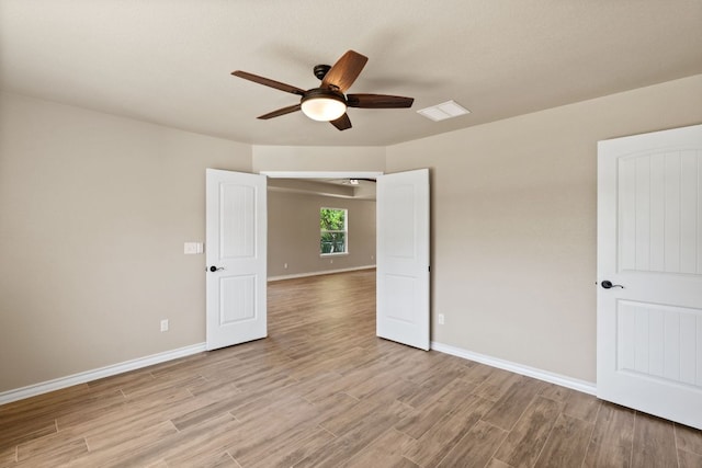 125 Channel Dr, Sunrise Beach, TX 78643 - unfurnished bedroom with a ceiling fan, light wood-style flooring, and baseboards