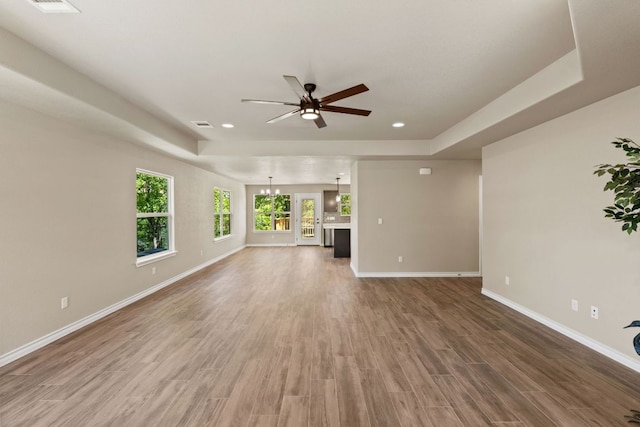 125 Channel Dr, Sunrise Beach, TX 78643 - unfurnished living room featuring recessed lighting, light wood finished floors, baseboards, a raised ceiling, and a ceiling fan