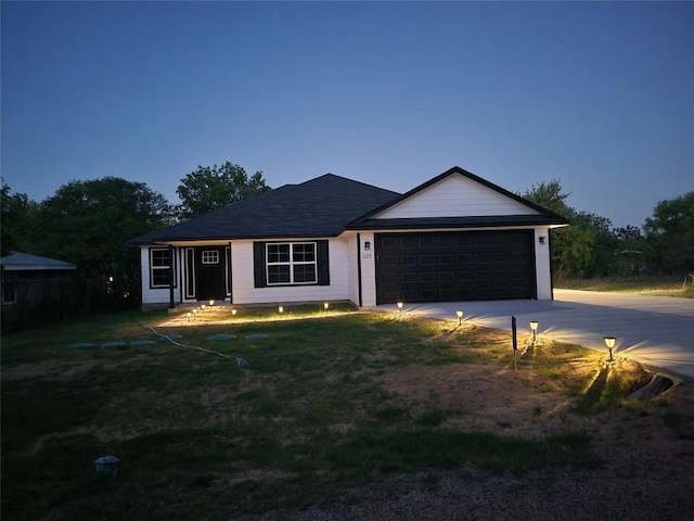 125 Channel Dr, Sunrise Beach, TX 78643 - ranch-style home with driveway, a front yard, and an attached garage
