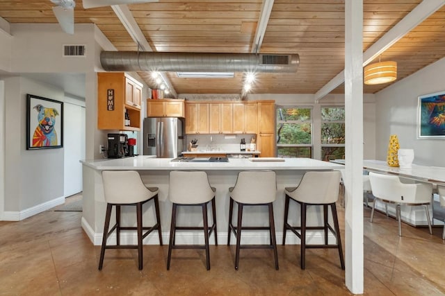 2301 Westway Cir, Austin, TX 78704 - kitchen featuring stainless steel fridge with ice dispenser, wood ceiling with exposed beams, light countertops, a kitchen bar, and light brown cabinets