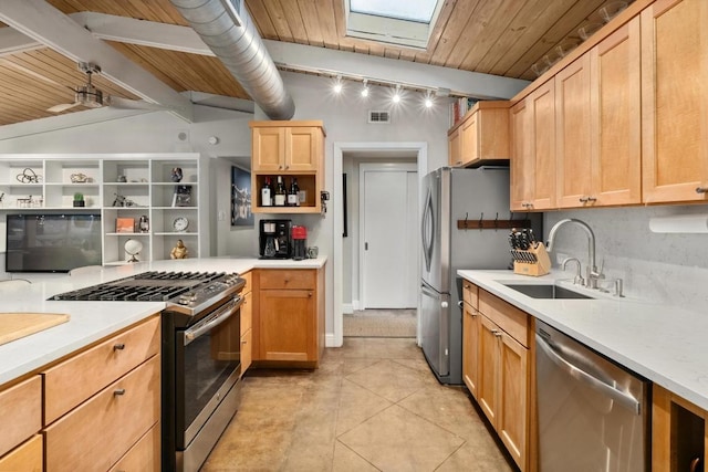 2301 Westway Cir, Austin, TX 78704 - kitchen featuring stainless steel appliances, a sink, light countertops, a skylight, and wooden ceiling with exposed beams