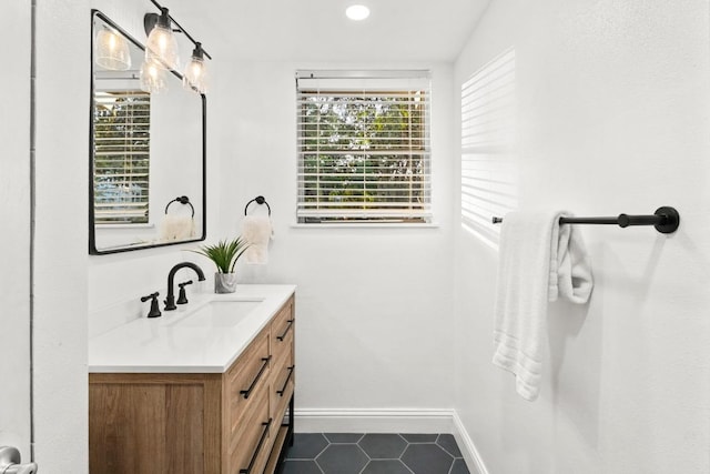 2301 Westway Cir, Austin, TX 78704 - bathroom with vanity, tile patterned flooring, baseboards, and recessed lighting