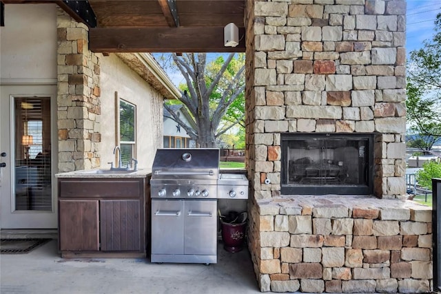 202 Bridgepoint Dr, Kingsland, TX 78639 - view of patio / terrace featuring an outdoor stone fireplace and a sink