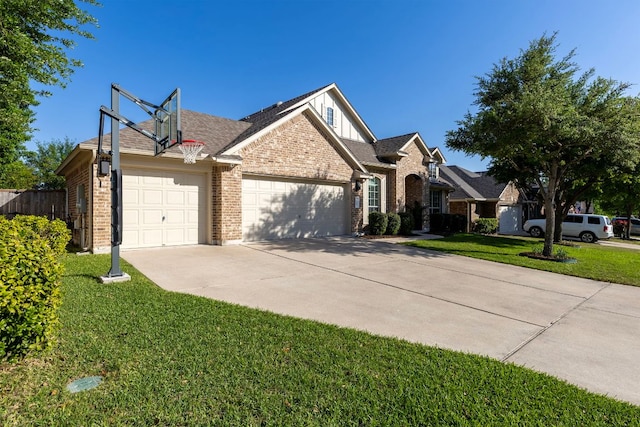 view of front of house with concrete driveway, a front yard, brick siding, and an attached garage