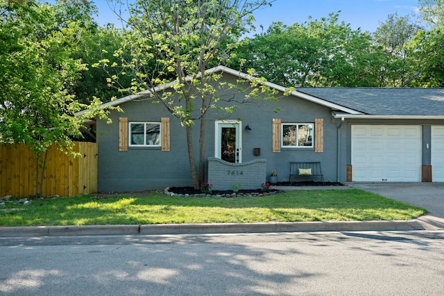 7614 Watson St, Austin, TX 78757 - view of front of home featuring an attached garage, driveway, and stucco siding