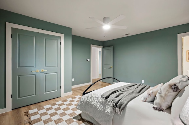7614 Watson St, Austin, TX 78757 - bedroom with a closet, light wood-style flooring, ceiling fan, and baseboards