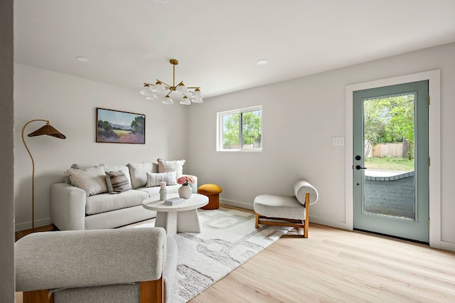 7614 Watson St, Austin, TX 78757 - living room featuring a chandelier, light wood-type flooring, baseboards, and recessed lighting