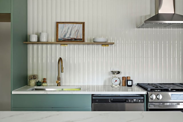 7614 Watson St, Austin, TX 78757 - kitchen with wall chimney exhaust hood, appliances with stainless steel finishes, a sink, decorative backsplash, and light stone countertops