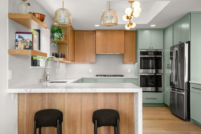 4328 Far W Blvd, Austin, TX 78731 - kitchen with open shelves, a sink, stainless steel appliances, a peninsula, and light wood-type flooring