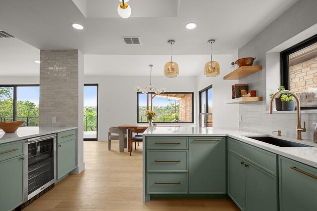 4328 Far W Blvd, Austin, TX 78731 - kitchen with visible vents, wine cooler, a peninsula, green cabinetry, and a sink
