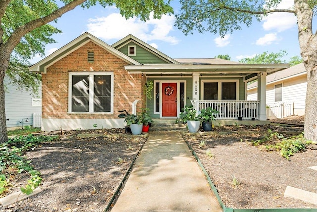 4456 Mather, Kyle, TX 78640 - view of front facade featuring covered porch and brick siding