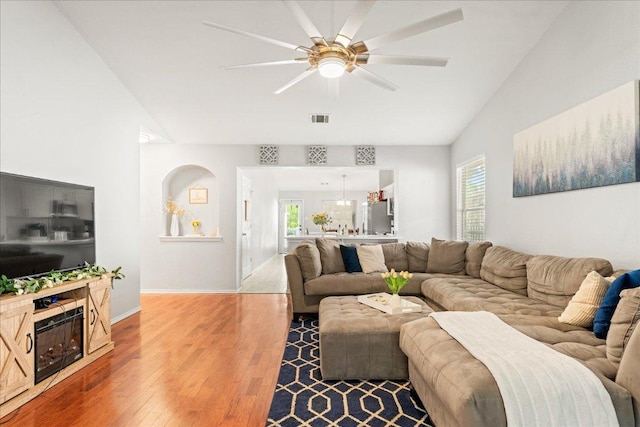 4456 Mather, Kyle, TX 78640 - living area featuring lofted ceiling, wood finished floors, ceiling fan, baseboards, and a fireplace