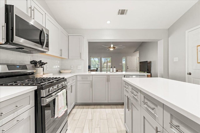 4456 Mather, Kyle, TX 78640 - kitchen with stainless steel appliances, light countertops, backsplash, recessed lighting, and a ceiling fan