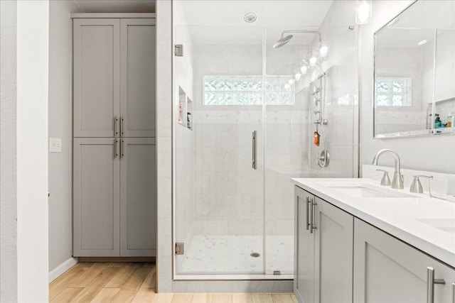 4456 Mather, Kyle, TX 78640 - full bathroom featuring a shower stall, double vanity, and wood finished floors
