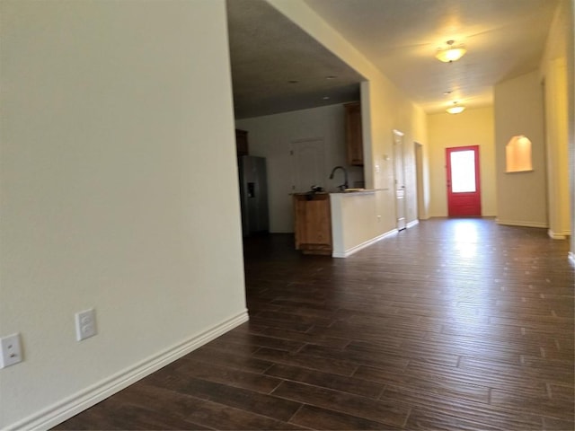 entryway with baseboards and dark wood-type flooring