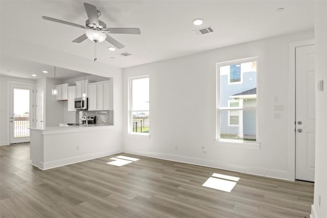 2031 Cora Ivy Ln, Round Rock, TX 78665 - unfurnished living room featuring light wood finished floors, baseboards, a ceiling fan, and recessed lighting