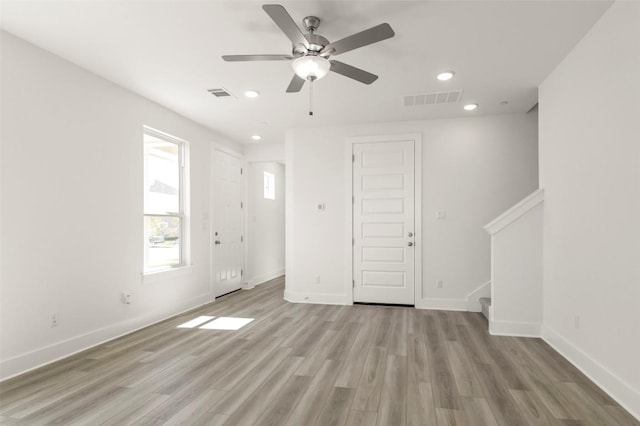2031 Cora Ivy Ln, Round Rock, TX 78665 - unfurnished living room with stairway, light wood-style flooring, a ceiling fan, baseboards, and recessed lighting