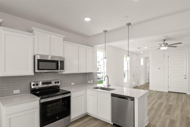 2031 Cora Ivy Ln, Round Rock, TX 78665 - kitchen featuring stainless steel appliances, a sink, backsplash, light countertops, and recessed lighting