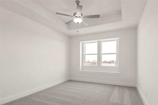 2031 Cora Ivy Ln, Round Rock, TX 78665 - spare room with baseboards, light colored carpet, a tray ceiling, and ceiling fan
