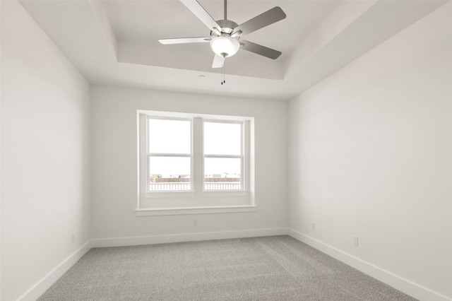 2031 Cora Ivy Ln, Round Rock, TX 78665 - unfurnished room featuring a tray ceiling, baseboards, and light carpet