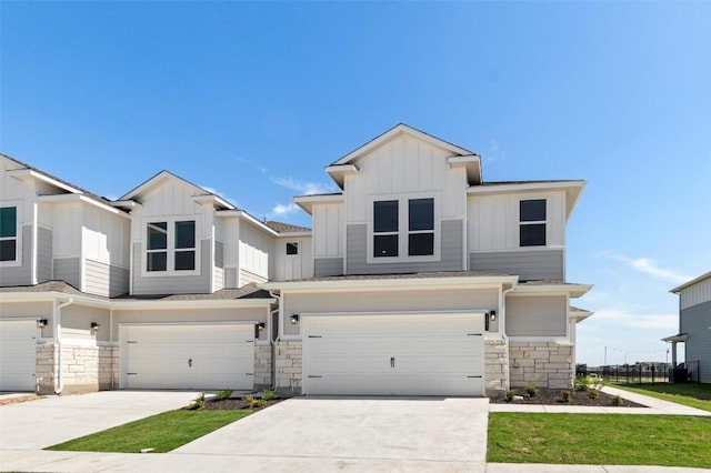 2031 Cora Ivy Ln, Round Rock, TX 78665 - view of front of home with a garage, stone siding, board and batten siding, and driveway