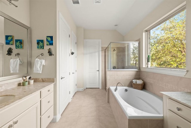 bathroom featuring a shower stall, vanity, a garden tub, tile patterned floors, and baseboards