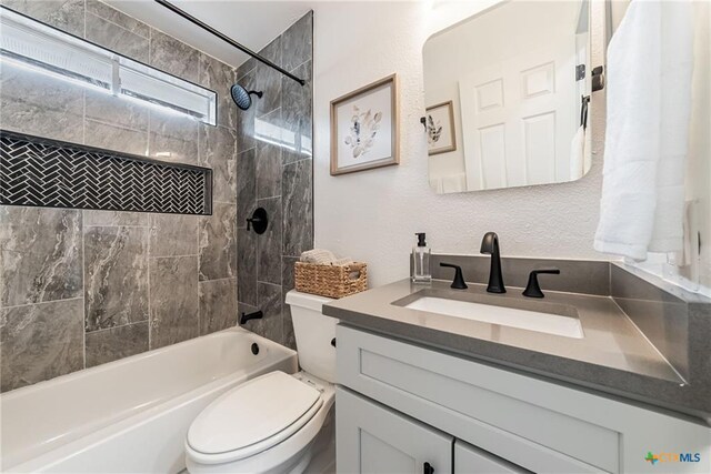 full bath featuring toilet, vanity, and bathtub / shower combination