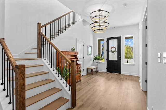 1890 Headwaters Blvd, Dripping Springs, TX 78620 - entryway with wood finished floors, a chandelier, and stairs