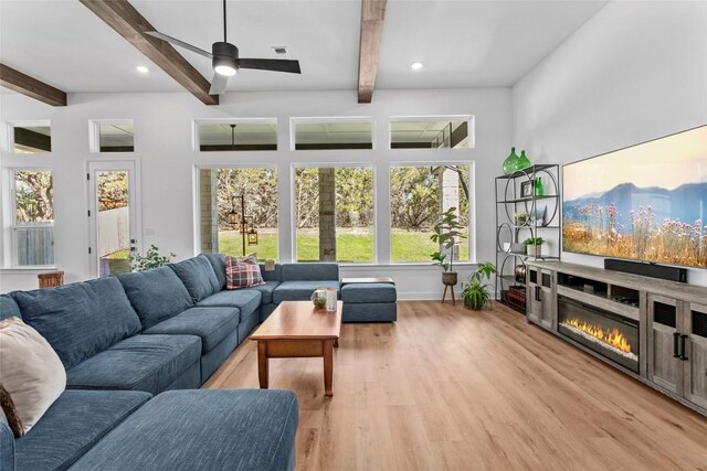 1890 Headwaters Blvd, Dripping Springs, TX 78620 - living area featuring beamed ceiling, light wood finished floors, ceiling fan, a glass covered fireplace, and recessed lighting