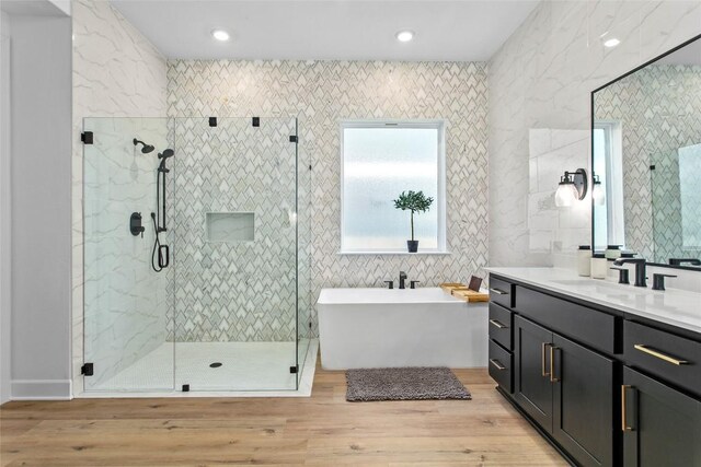 1890 Headwaters Blvd, Dripping Springs, TX 78620 - bathroom featuring a freestanding bath, vanity, a shower stall, wood finished floors, and recessed lighting