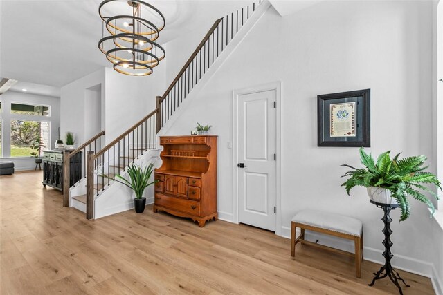 1890 Headwaters Blvd, Dripping Springs, TX 78620 - stairs featuring wood finished floors, a high ceiling, recessed lighting, and a chandelier