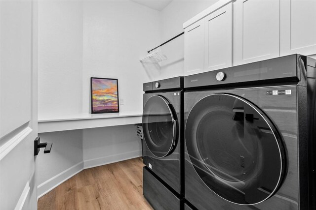 1890 Headwaters Blvd, Dripping Springs, TX 78620 - washroom featuring independent washer and dryer, cabinet space, and light wood-style floors