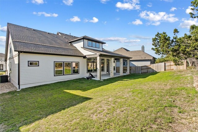 1890 Headwaters Blvd, Dripping Springs, TX 78620 - back of property with a patio area and roof with shingles