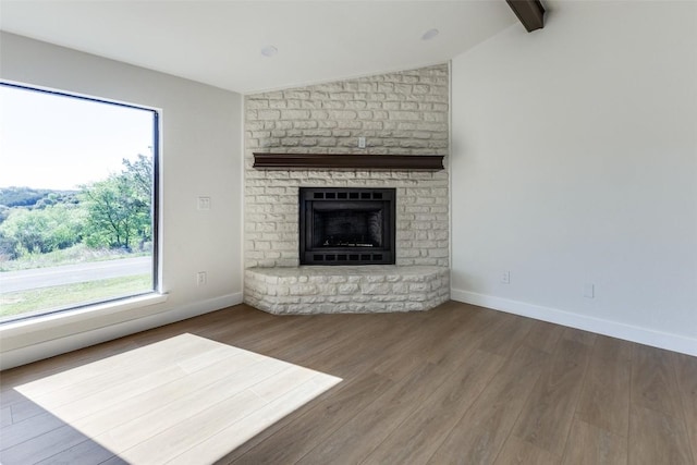 3004 Boone Dr, Lago Vista, TX 78645 - unfurnished living room featuring wood finished floors and a brick fireplace