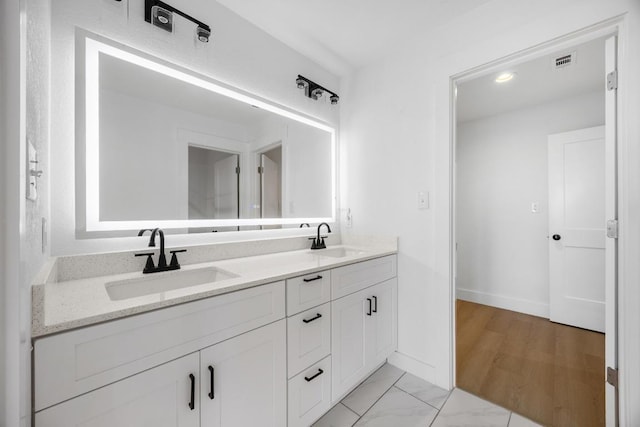 240 Hanauma Dr, Bastrop, TX 78602 - bathroom with double vanity, baseboards, and marble look tile flooring
