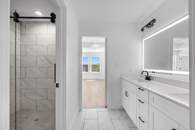 240 Hanauma Dr, Bastrop, TX 78602 - full bath with marble look tile flooring, tiled shower, baseboards, and double vanity