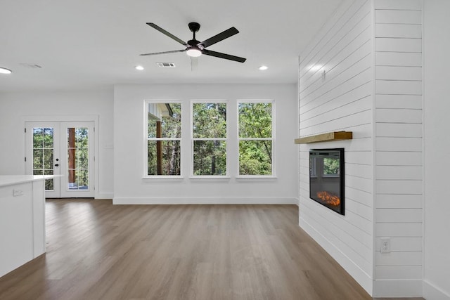 240 Hanauma Dr, Bastrop, TX 78602 - unfurnished living room featuring baseboards, wood finished floors, plenty of natural light, and recessed lighting