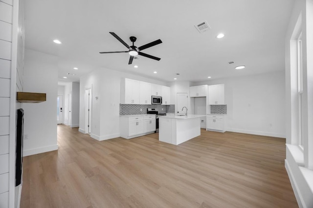 240 Hanauma Dr, Bastrop, TX 78602 - kitchen with open floor plan, a sink, appliances with stainless steel finishes, tasteful backsplash, and recessed lighting