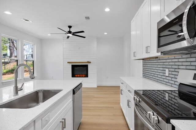 240 Hanauma Dr, Bastrop, TX 78602 - kitchen featuring stainless steel appliances, a sink, recessed lighting, tasteful backsplash, and ceiling fan