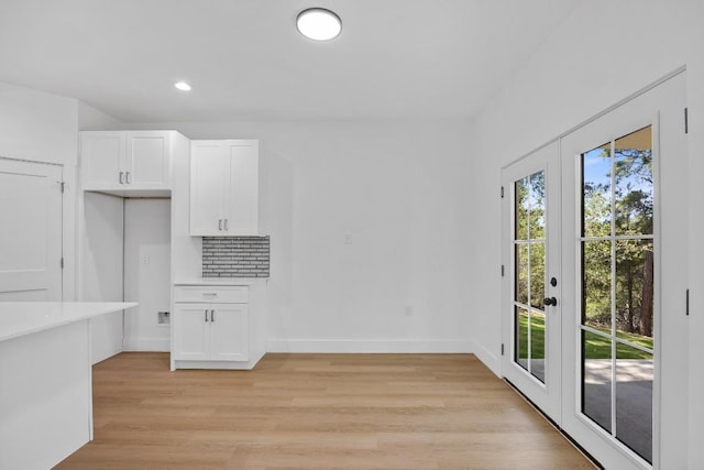 240 Hanauma Dr, Bastrop, TX 78602 - unfurnished dining area with light wood-type flooring, baseboards, recessed lighting, and french doors
