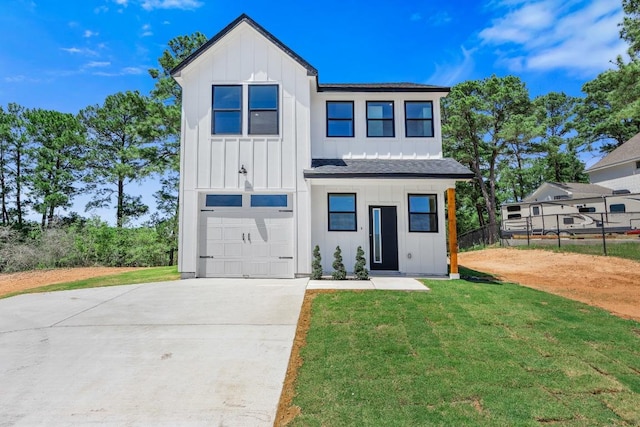 240 Hanauma Dr, Bastrop, TX 78602 - view of front facade with board and batten siding, a garage, driveway, and roof with shingles