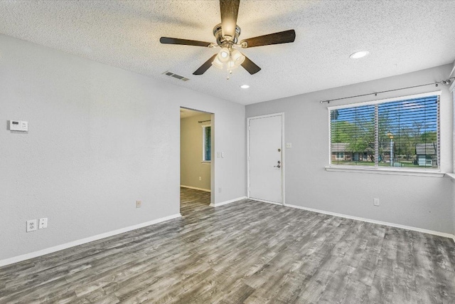 317 W William Cannon Dr B, Unit A, Austin, TX 78745 - spare room with a textured ceiling, wood finished floors, a ceiling fan, and baseboards
