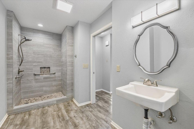 317 W William Cannon Dr B, Unit A, Austin, TX 78745 - bathroom featuring walk in shower, wood finished floors, and a textured ceiling