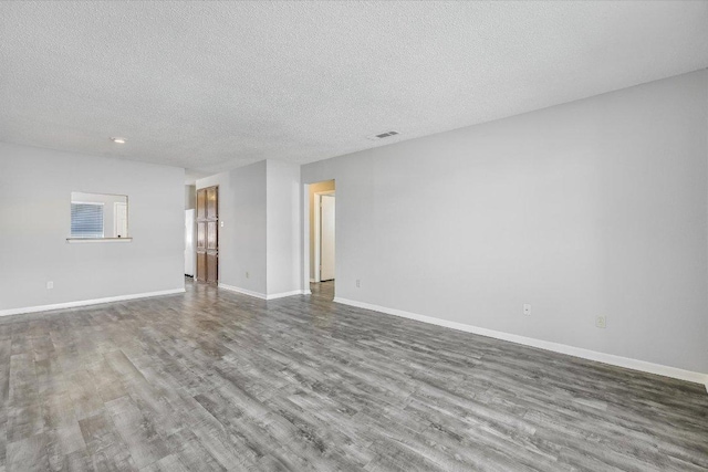 317 W William Cannon Dr B, Unit A, Austin, TX 78745 - unfurnished room with wood finished floors, baseboards, a textured ceiling, and recessed lighting