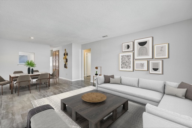 317 W William Cannon Dr B, Unit A, Austin, TX 78745 - living room with a textured ceiling, wood finished floors, and baseboards