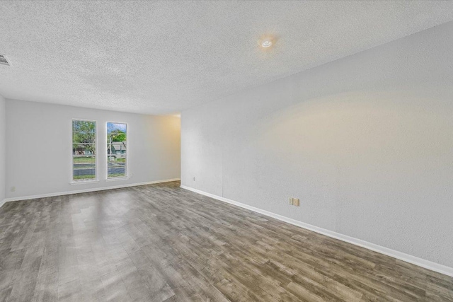 317 W William Cannon Dr B, Unit A, Austin, TX 78745 - spare room with dark wood-style flooring and a textured ceiling